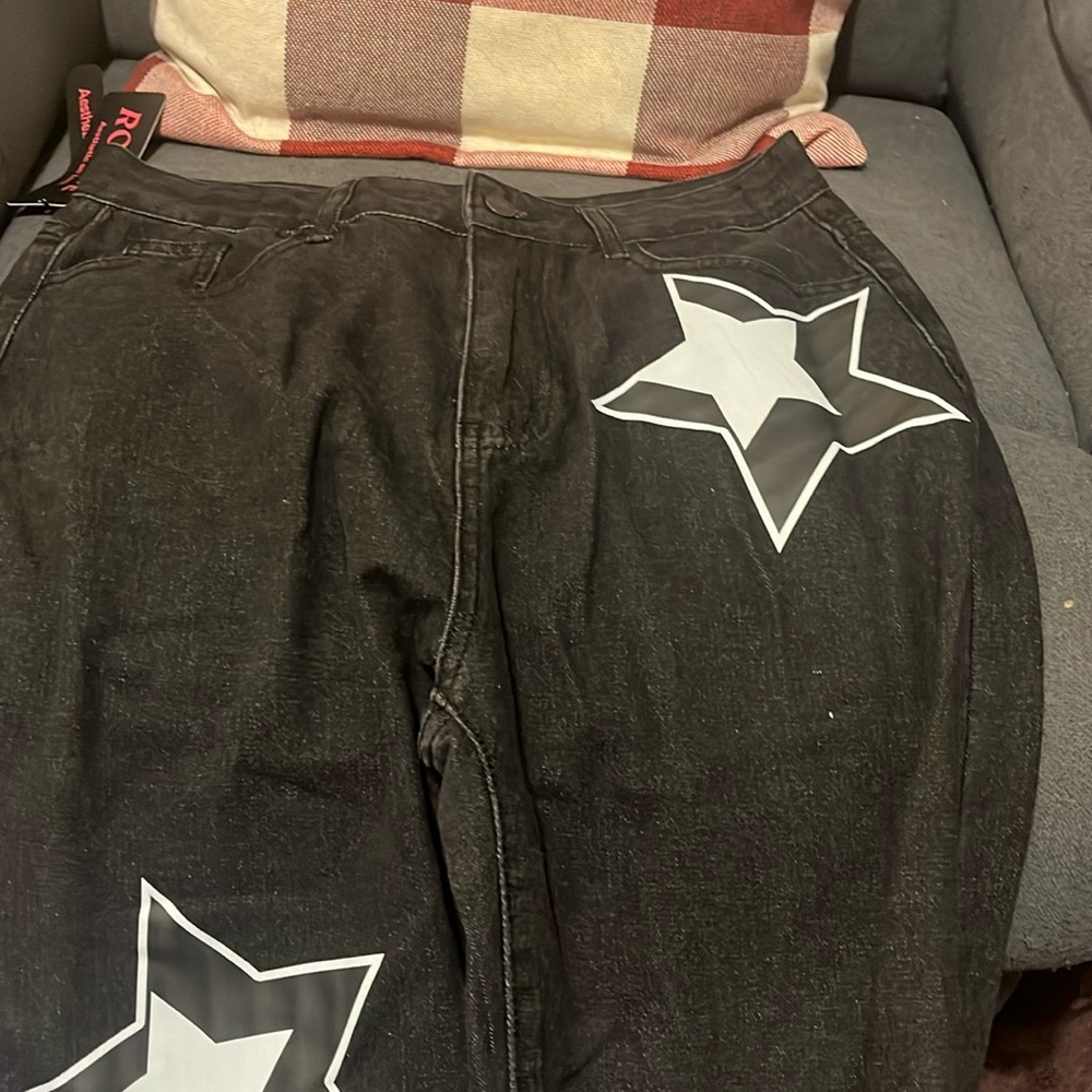 Junior black jeans with white stars and the jeans are a L